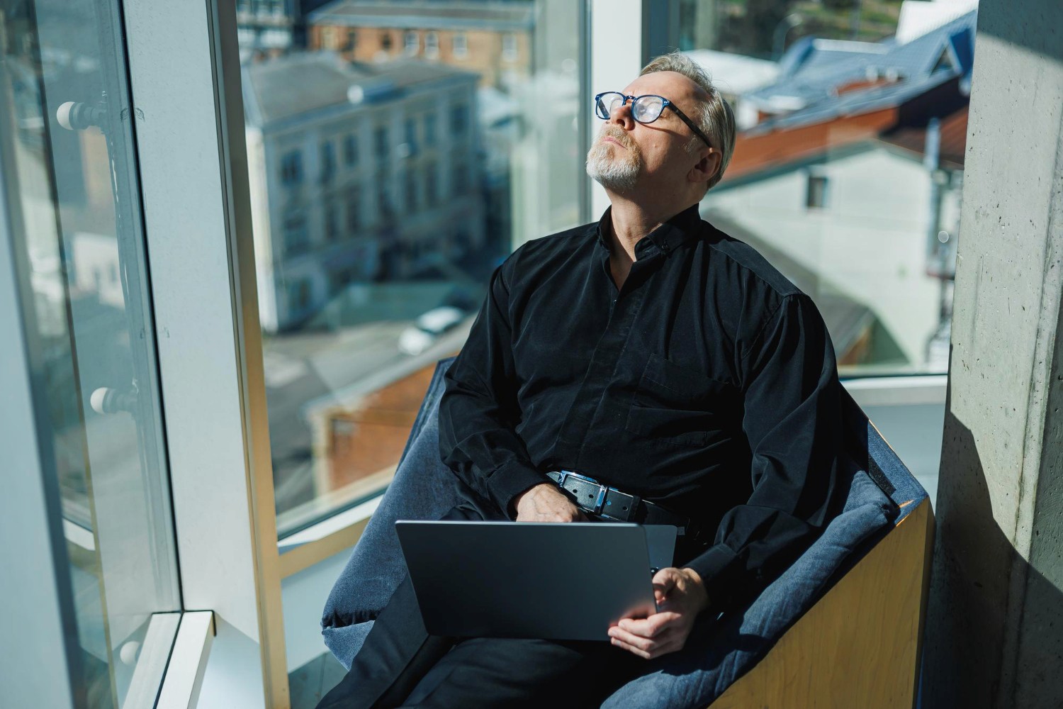 A leader reflecting in a modern workplace